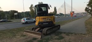 Yanmar compact excavator beside a road