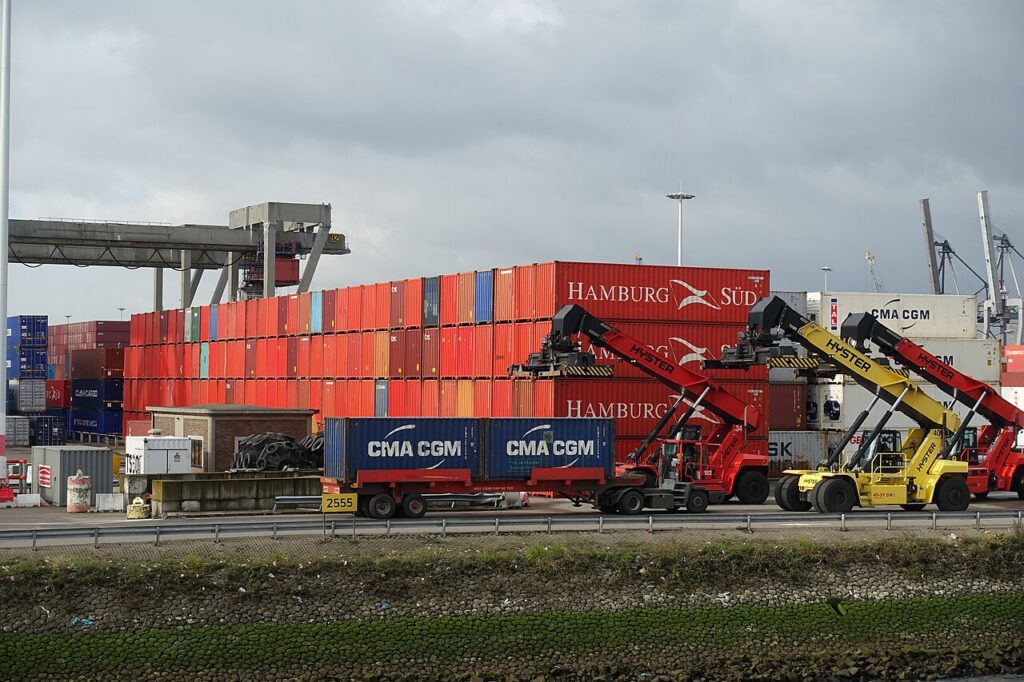Stacked shipping containers and container handling equipment at Rotterdam