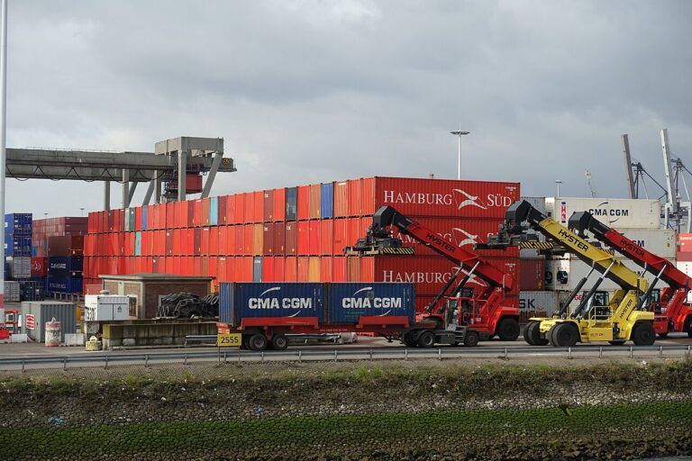 Stacked shipping containers and container handling equipment at Rotterdam