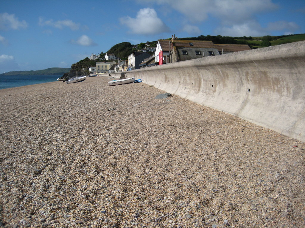 Shingle beach beside the sea wall and houses at Torcross